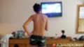Bik topless hand on hip wearing shorts