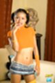 Hand raised wearing orange top short skirt