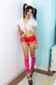 Bunni standing against wall raising short skirt in high heels