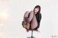 Knees drawn up black pantyhose