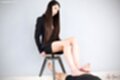 Sitting on stool long hair falling over her chest giving footjob bare feet