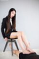 Sitting on stool long hair giving footjob bare feet