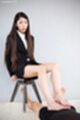 Seated on stool long hair looking down giving footjob bare feet