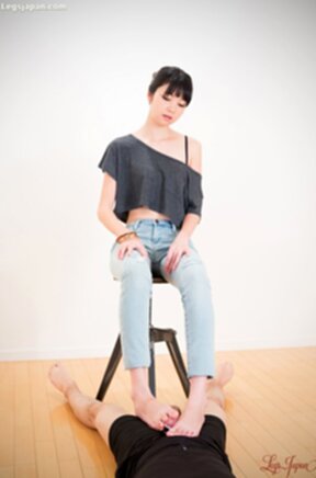 Matsuda Anna sitting on stool wearing jeans giving footjob with bare feet