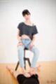 Matsuda anna sitting on stool looking down hands on her thighs in jeans giving footjob bare feet