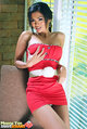 Meena yen leaning against chair wearing red dress hand raised to breast upskirt panties