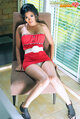 Sitting on chair in red dress upskirt panties thighs pressed together in high heels