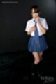 Wearing student uniform adjusting her tie