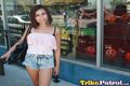 Standing outside halloween shop short hair wearing denim shorts